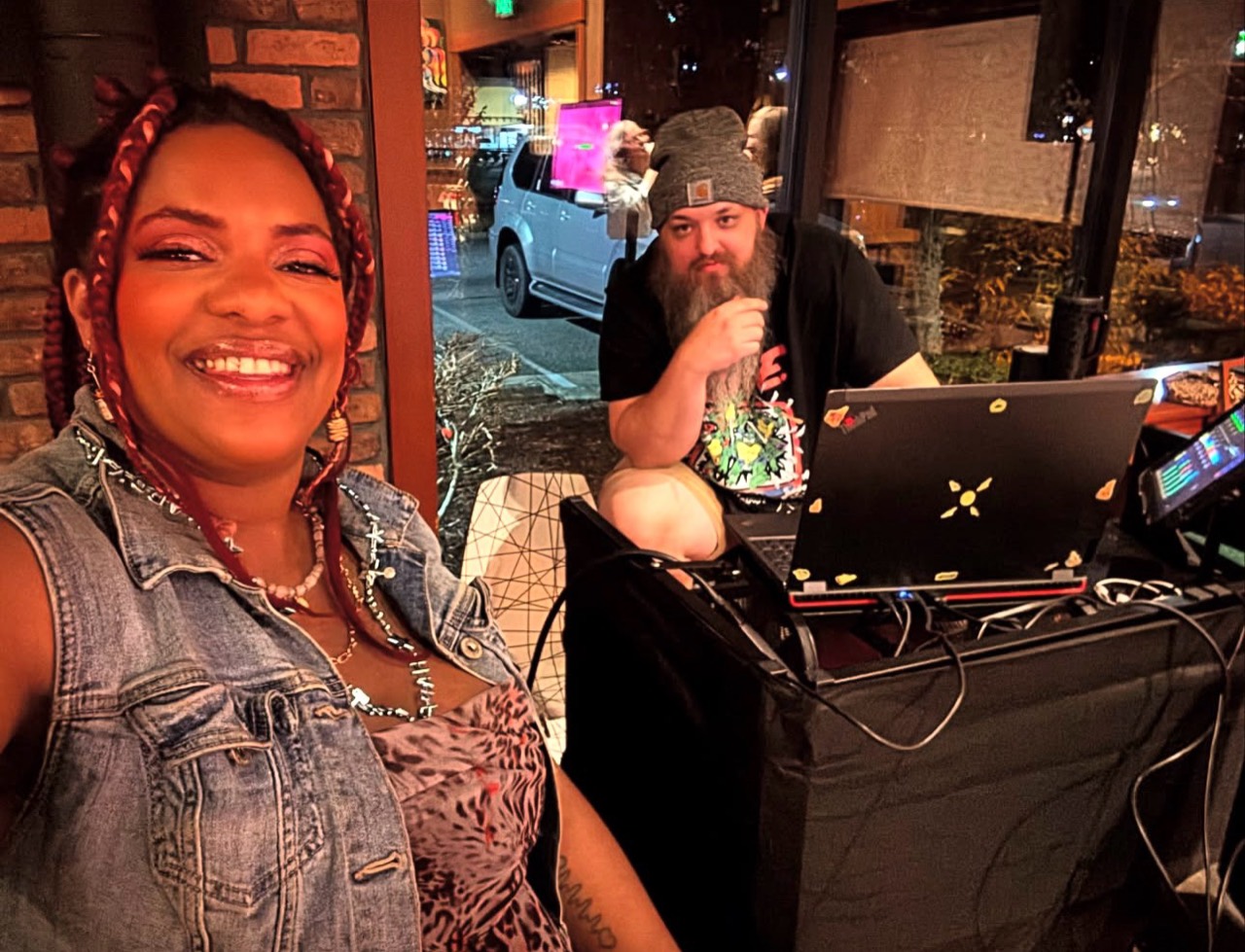 Kellie and Justin together beside their laptop and event audio setup.